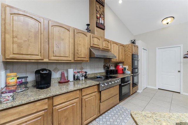 kitchen with stainless steel gas cooktop, tasteful backsplash, light stone counters, double oven, and light tile patterned floors