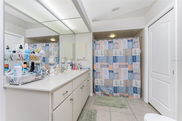 bathroom with tile patterned floors, vanity, and toilet