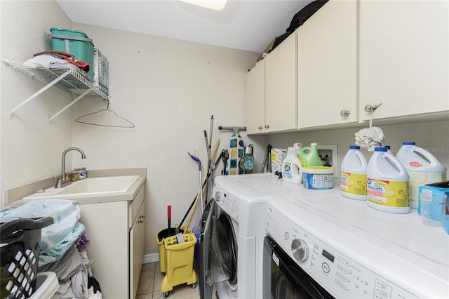 laundry area featuring cabinets, independent washer and dryer, light tile patterned floors, and sink