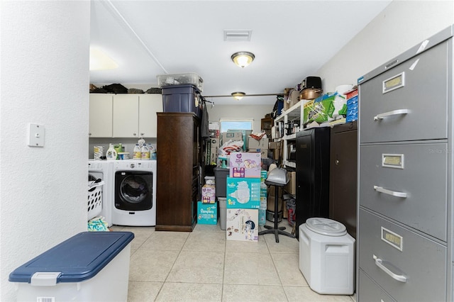 laundry room featuring washer and dryer and light tile patterned floors