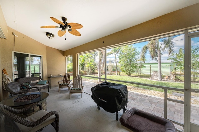 sunroom / solarium featuring ceiling fan and vaulted ceiling