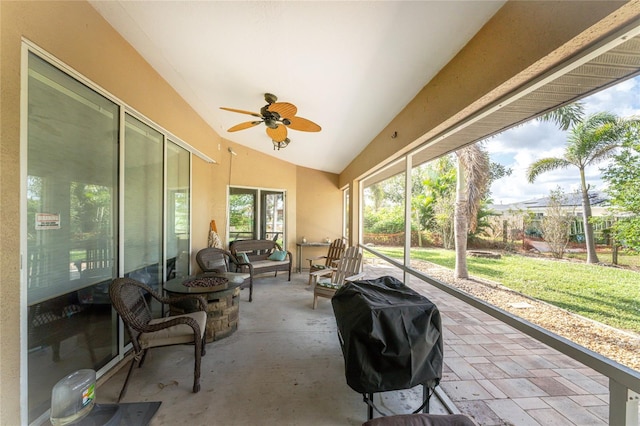 sunroom featuring ceiling fan and lofted ceiling