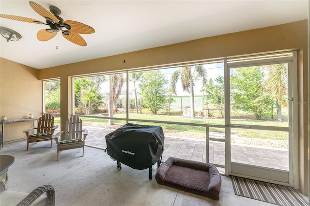 sunroom / solarium with plenty of natural light and ceiling fan