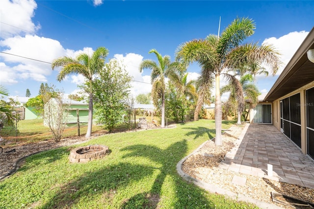 view of yard featuring an outdoor fire pit