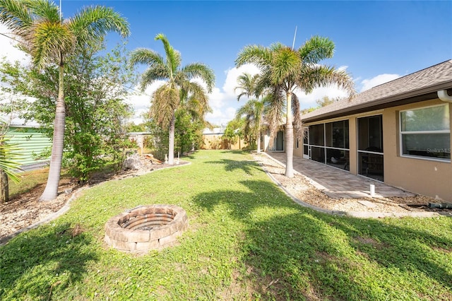 view of yard with a fire pit