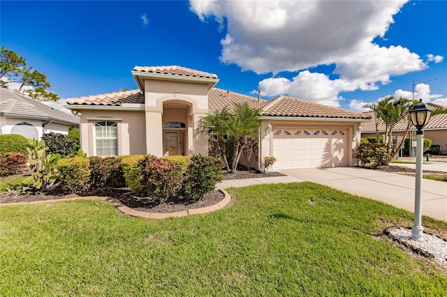 mediterranean / spanish house featuring a garage and a front yard