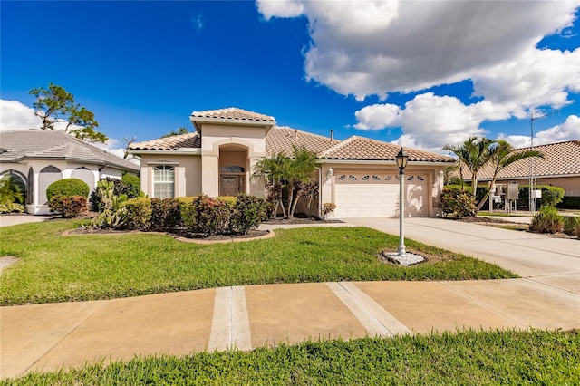 mediterranean / spanish house with a garage and a front yard