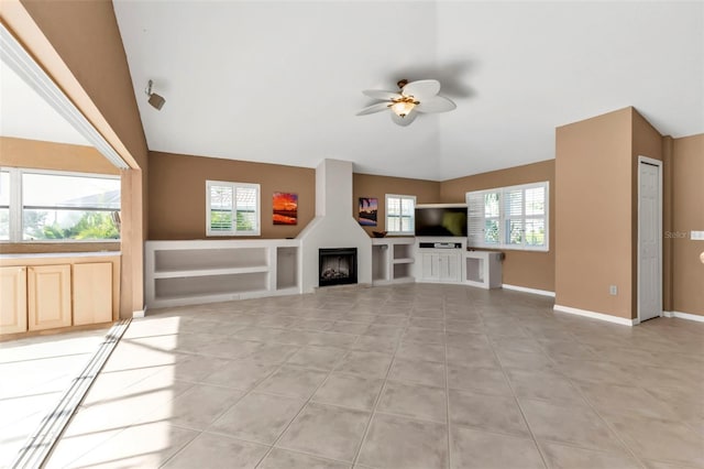 unfurnished living room with light tile patterned floors, ceiling fan, and a healthy amount of sunlight