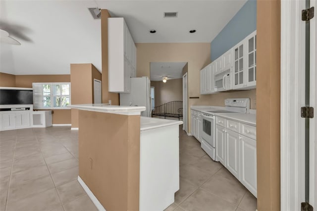 kitchen with light tile patterned floors, white appliances, white cabinetry, and ceiling fan