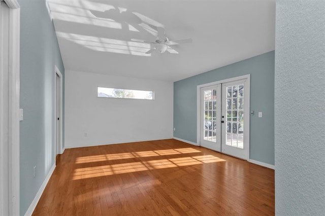 spare room with french doors, ceiling fan, and wood-type flooring