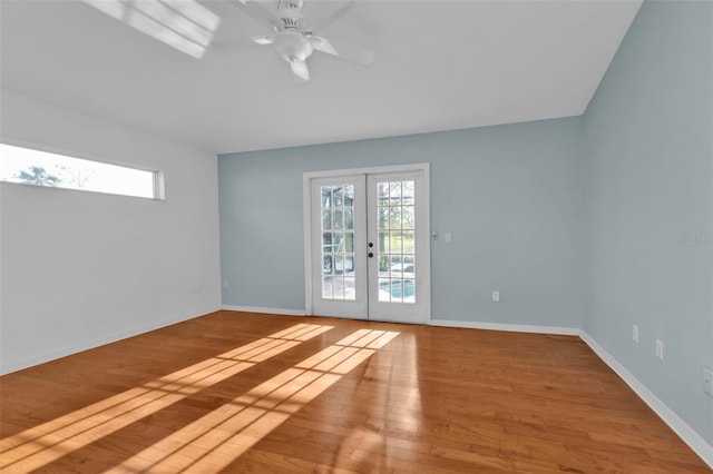 empty room with french doors, light hardwood / wood-style flooring, and ceiling fan