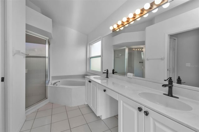 bathroom with tile patterned floors, vanity, and shower with separate bathtub