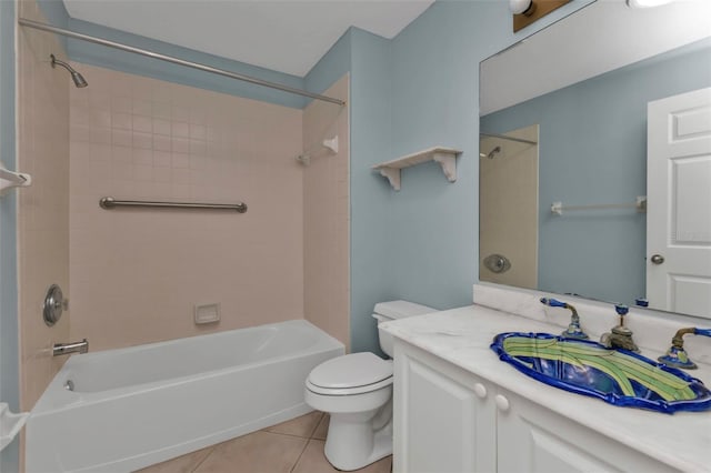 full bathroom with toilet, vanity, tiled shower / bath combo, and tile patterned floors