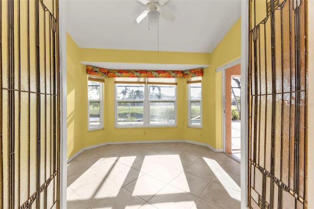 unfurnished sunroom with ceiling fan and vaulted ceiling