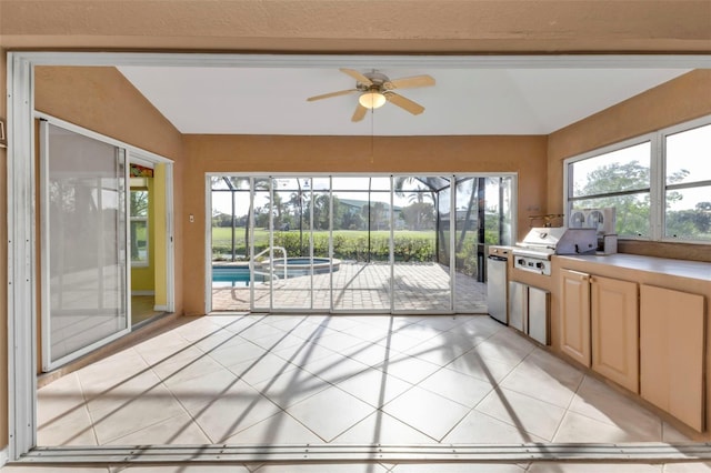 unfurnished sunroom with ceiling fan and lofted ceiling