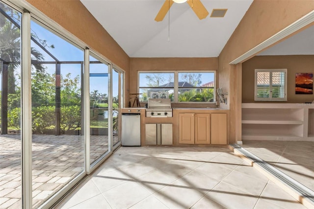 sunroom / solarium featuring a wealth of natural light, lofted ceiling, and ceiling fan