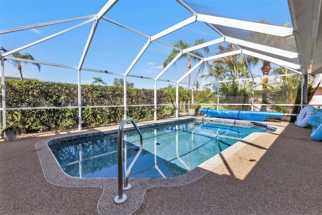 view of swimming pool featuring glass enclosure