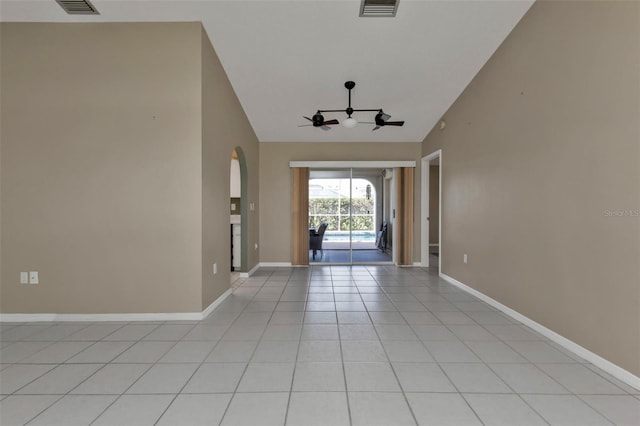 interior space with light tile patterned floors and high vaulted ceiling