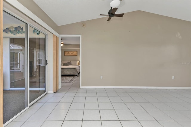 tiled spare room with ceiling fan and vaulted ceiling