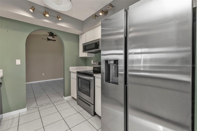 kitchen with white cabinetry, stainless steel appliances, and light tile patterned floors