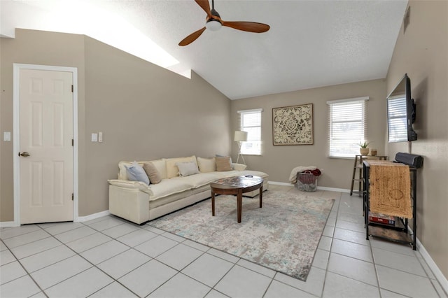 living room with ceiling fan, light tile patterned flooring, lofted ceiling, and a textured ceiling