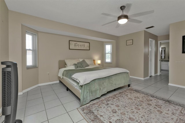 tiled bedroom with multiple windows and ceiling fan