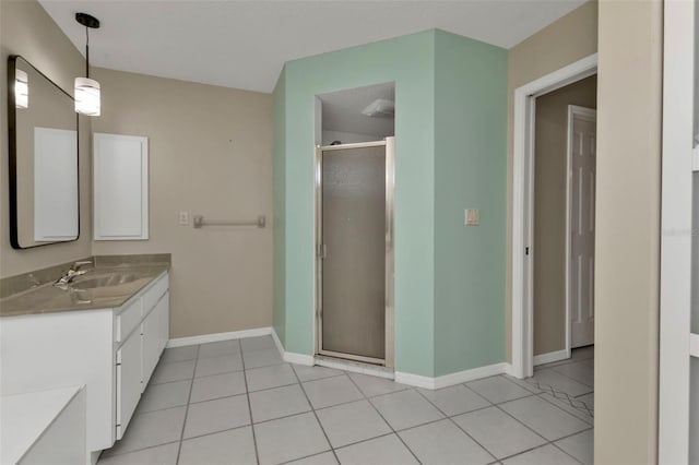 bathroom featuring tile patterned floors, vanity, and a shower with shower door