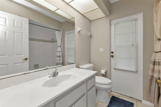 bathroom with tile patterned floors, vanity, toilet, and a shower with curtain