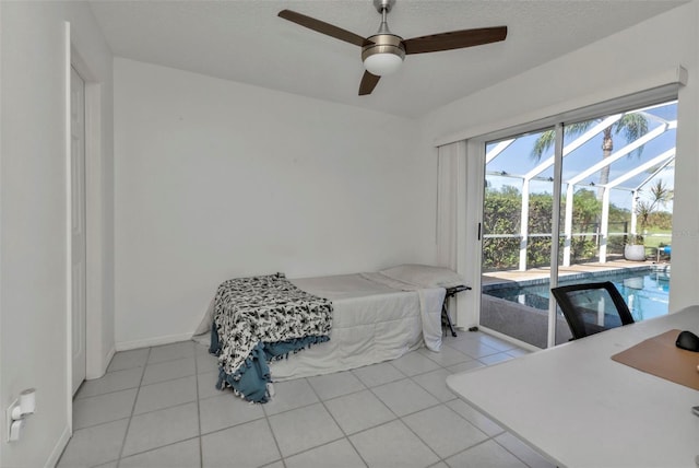 tiled bedroom with access to exterior, ceiling fan, and a textured ceiling