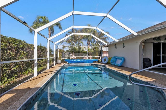 view of swimming pool with a lanai