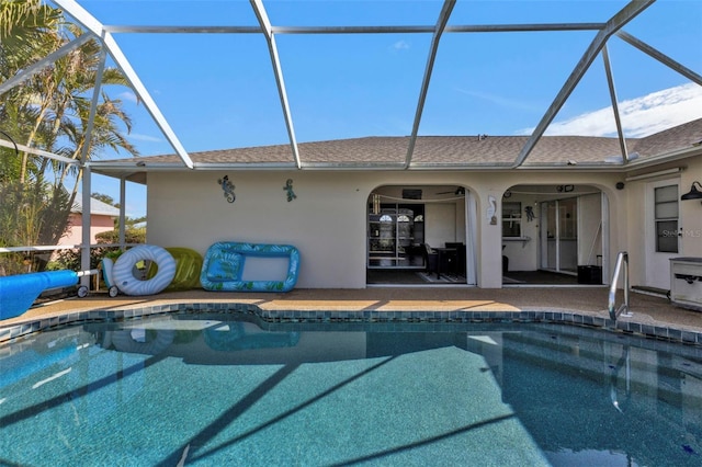 view of pool with a patio and glass enclosure