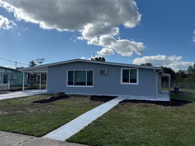 view of front of house with a carport and a front lawn