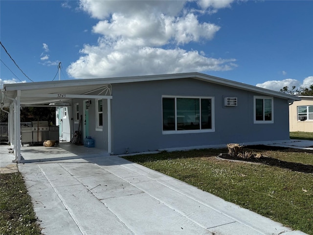 view of front of house with a front lawn and a carport