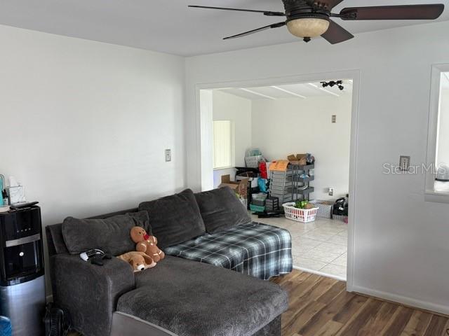 living room with hardwood / wood-style floors and ceiling fan