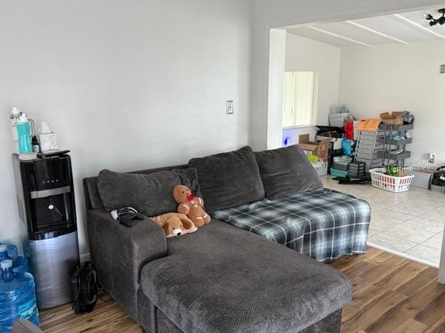 living room with beamed ceiling and wood-type flooring