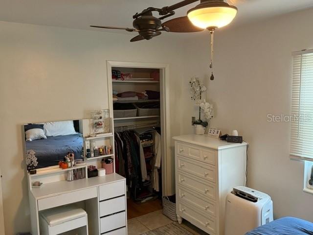 bedroom with ceiling fan and a closet