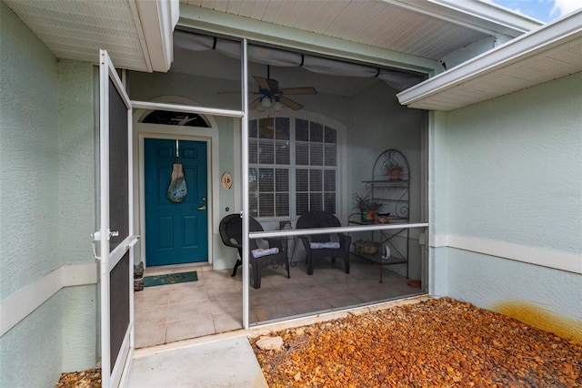 doorway to property featuring ceiling fan