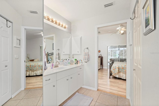 bathroom featuring ceiling fan, vanity, and tile patterned flooring