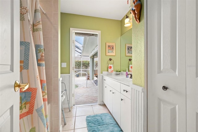 bathroom with tile patterned floors, walk in shower, and vanity