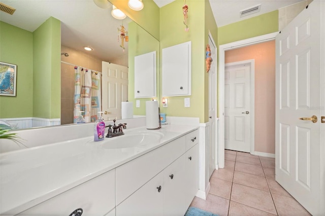 bathroom featuring curtained shower, tile patterned floors, and vanity