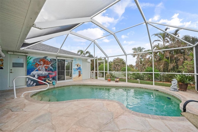 view of swimming pool with a patio area and glass enclosure