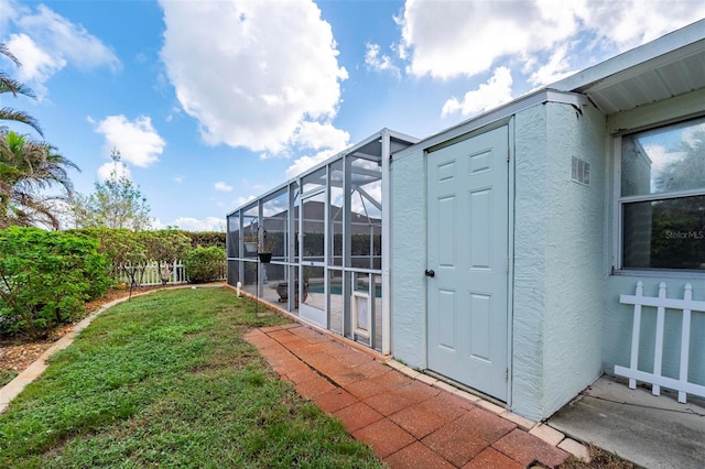 view of yard with glass enclosure