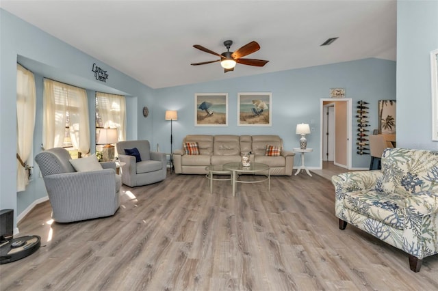 living room with ceiling fan, lofted ceiling, and light wood-type flooring