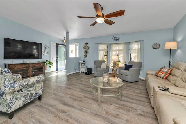 living room with ceiling fan, wood-type flooring, and lofted ceiling