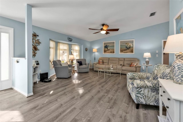 living room with ceiling fan, wood-type flooring, lofted ceiling, and plenty of natural light