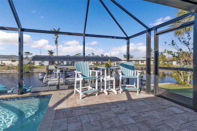 view of patio with glass enclosure, a water view, and a boat dock