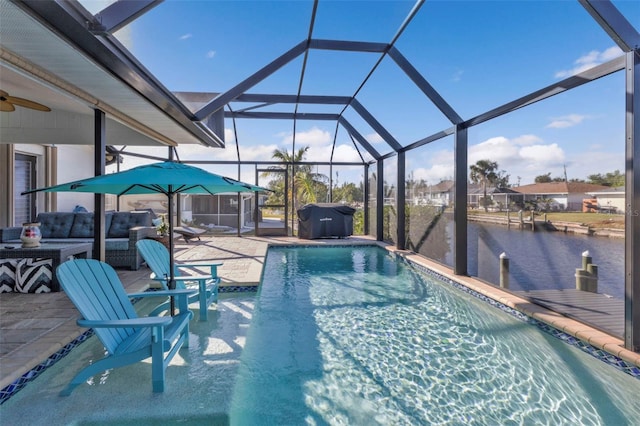 view of swimming pool featuring a lanai, an outdoor living space, a water view, grilling area, and a patio area