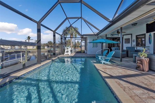 view of swimming pool with an outdoor hangout area, a lanai, a patio area, and ceiling fan