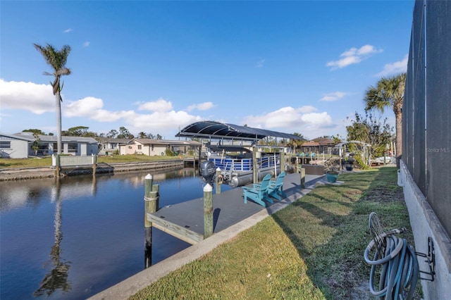 view of dock featuring a yard and a water view