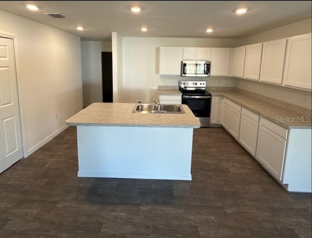 kitchen featuring sink, stainless steel appliances, dark hardwood / wood-style floors, white cabinets, and a center island with sink